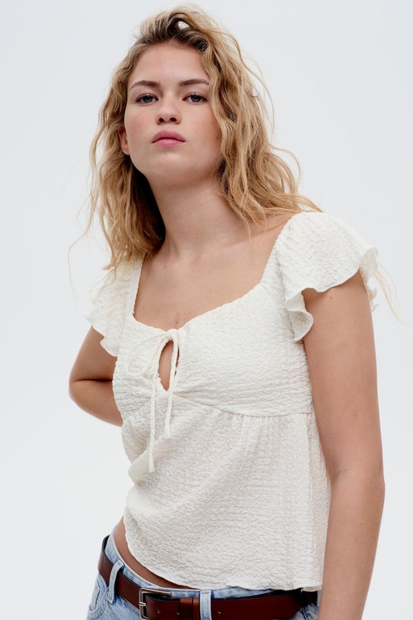 Blusa de mangas de volante en punto arrugado
