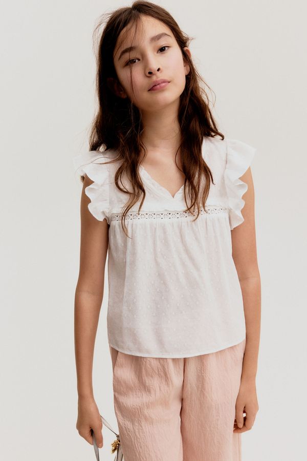 Blusa en algodón con ribetes de volante