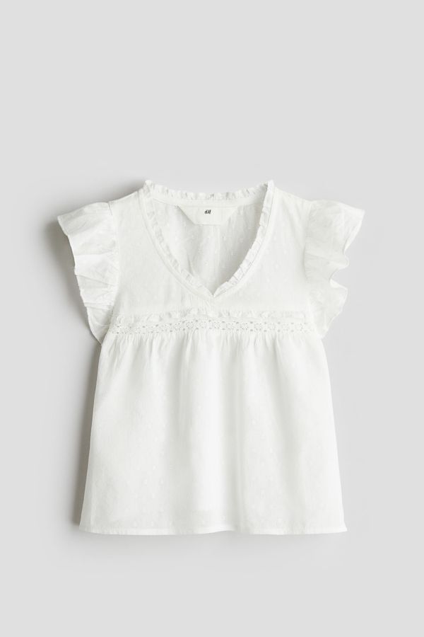 Blusa en algodón con ribetes de volante