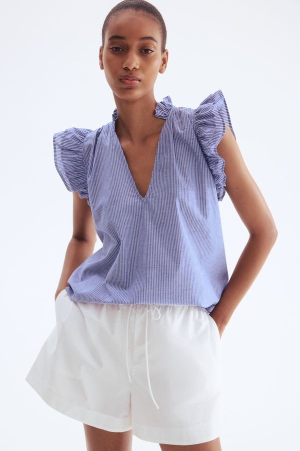 Blusa con ribetes de volante
