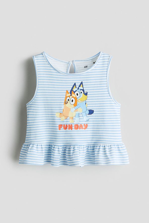 Camiseta con motivo estampado y peplum